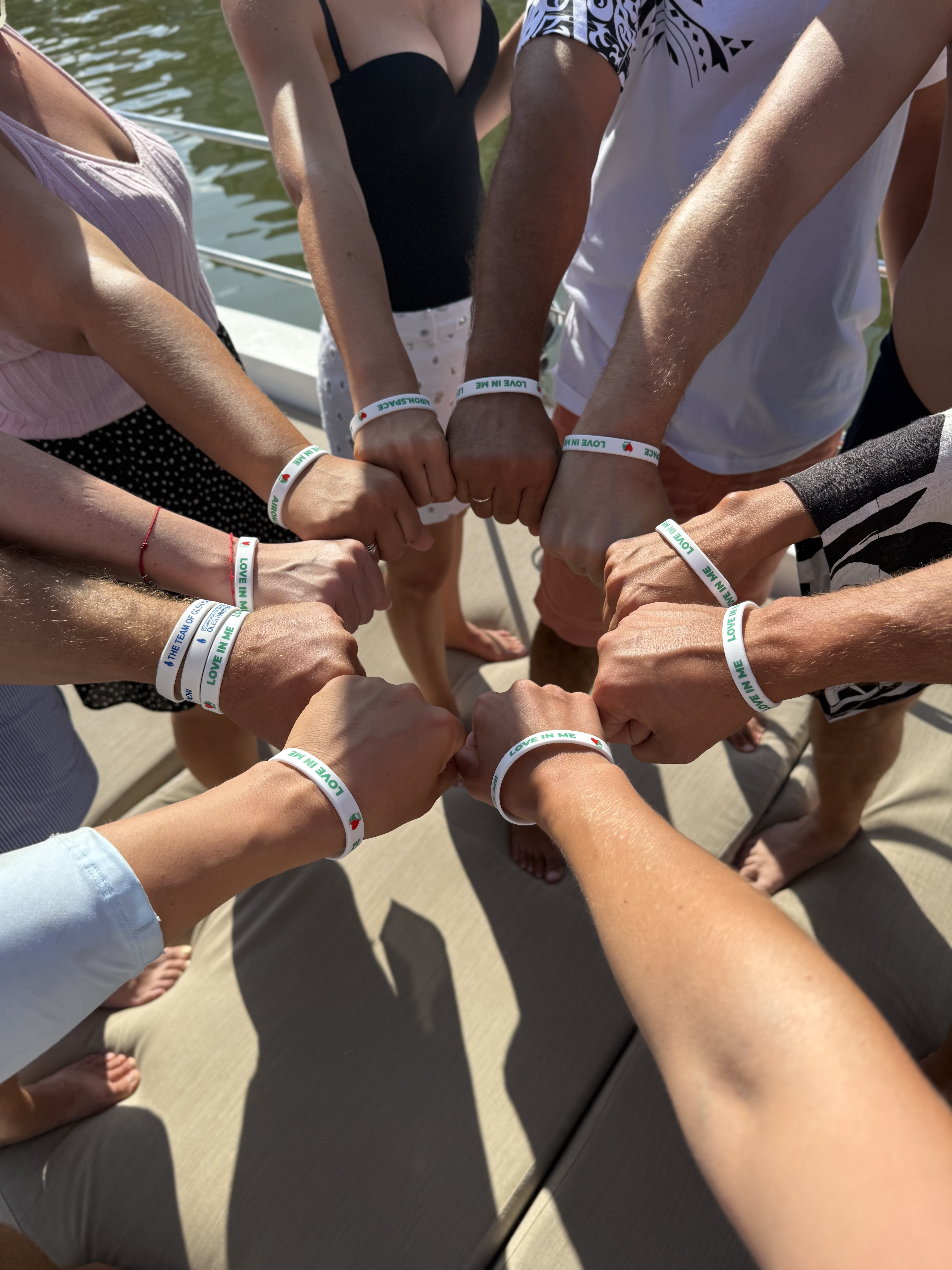 Crew fist-bumping with matching wristbands