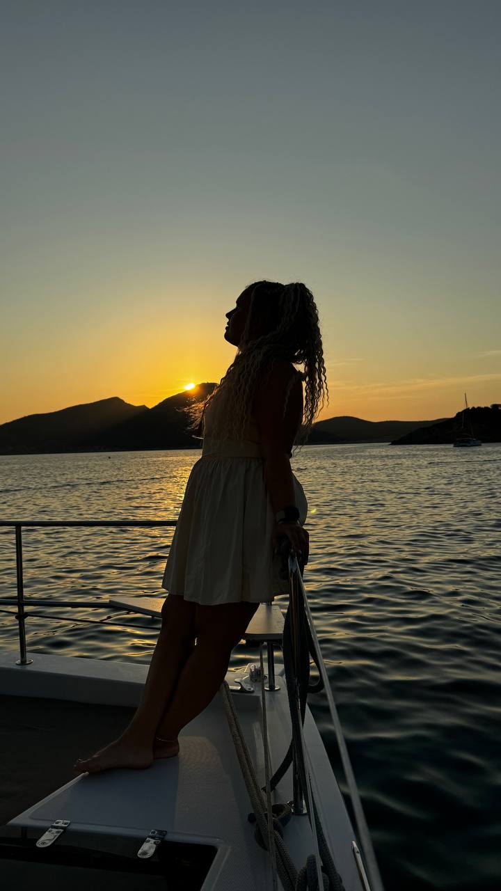Ana silhouette on the bow at golden hour sunset